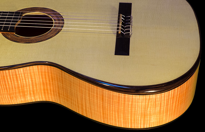 Flamed maple back and sides with a spruce/cedar doubletop and ebony bindings